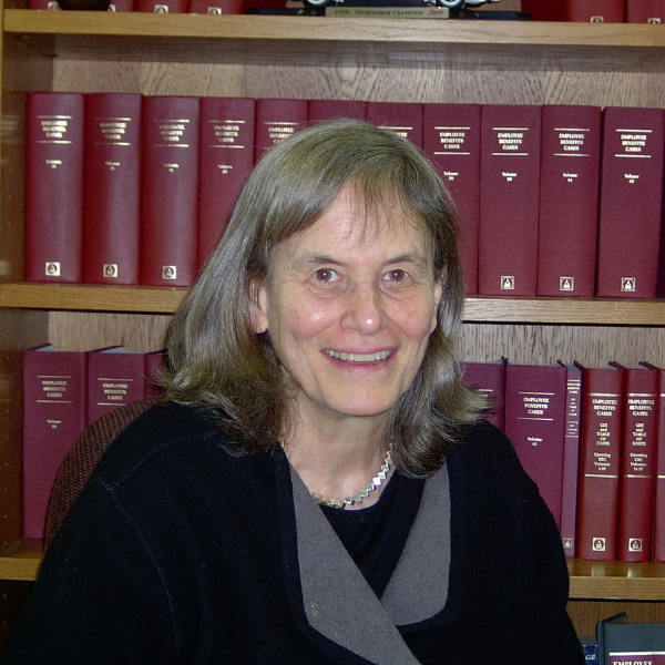 Photo of Karen Ferguson in front of bookshelf
