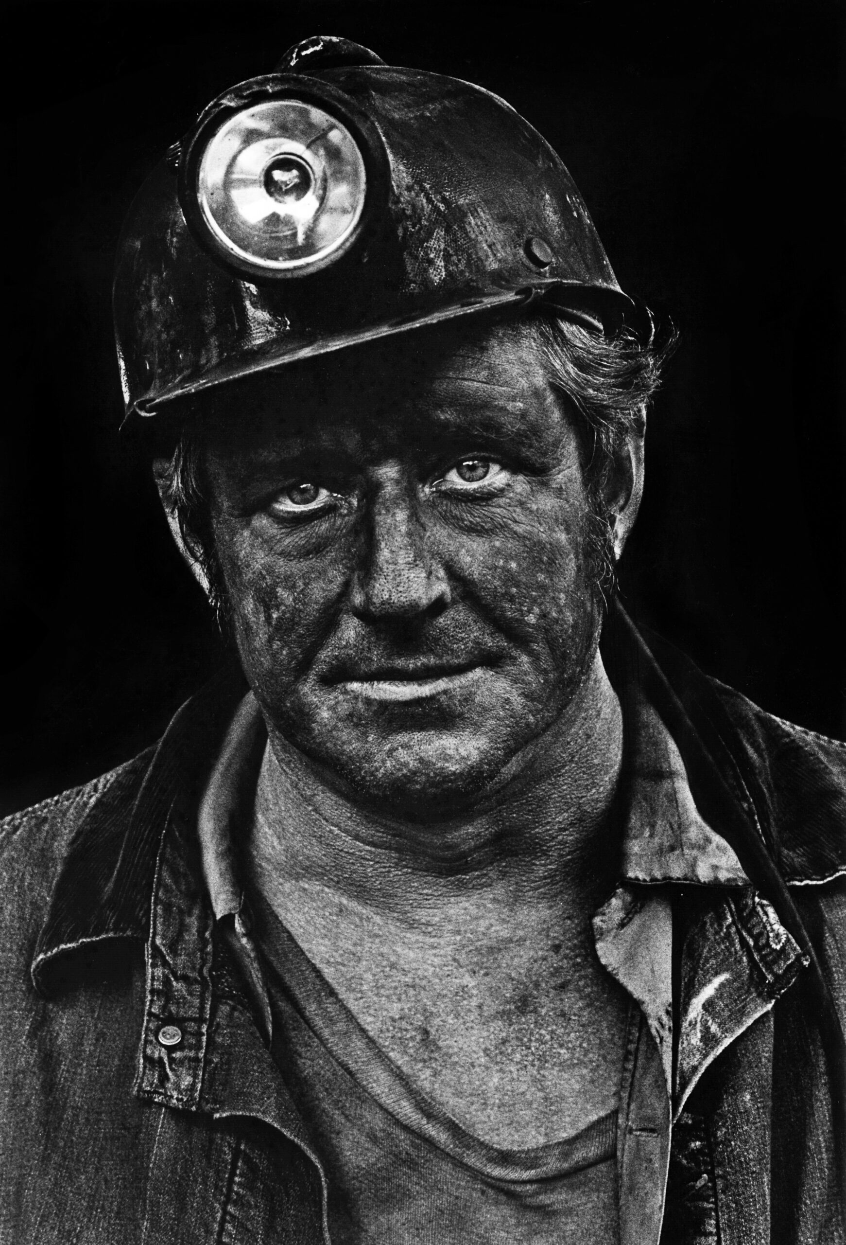 Coal miner Lee Hipshire looks into camera with coal dust on his face