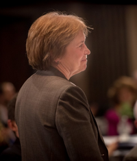 A photo depicts Pam Larson smiling in profile